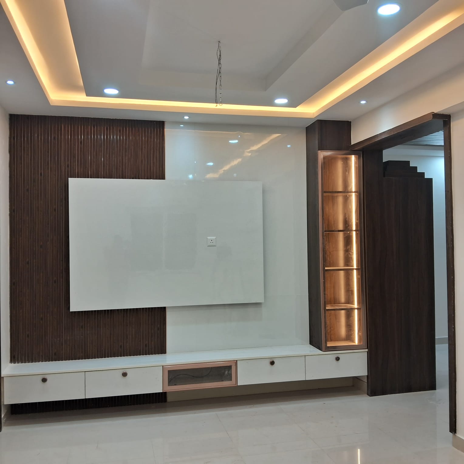Second TV unit wall with dark ribbed panelling and glossy backsplash