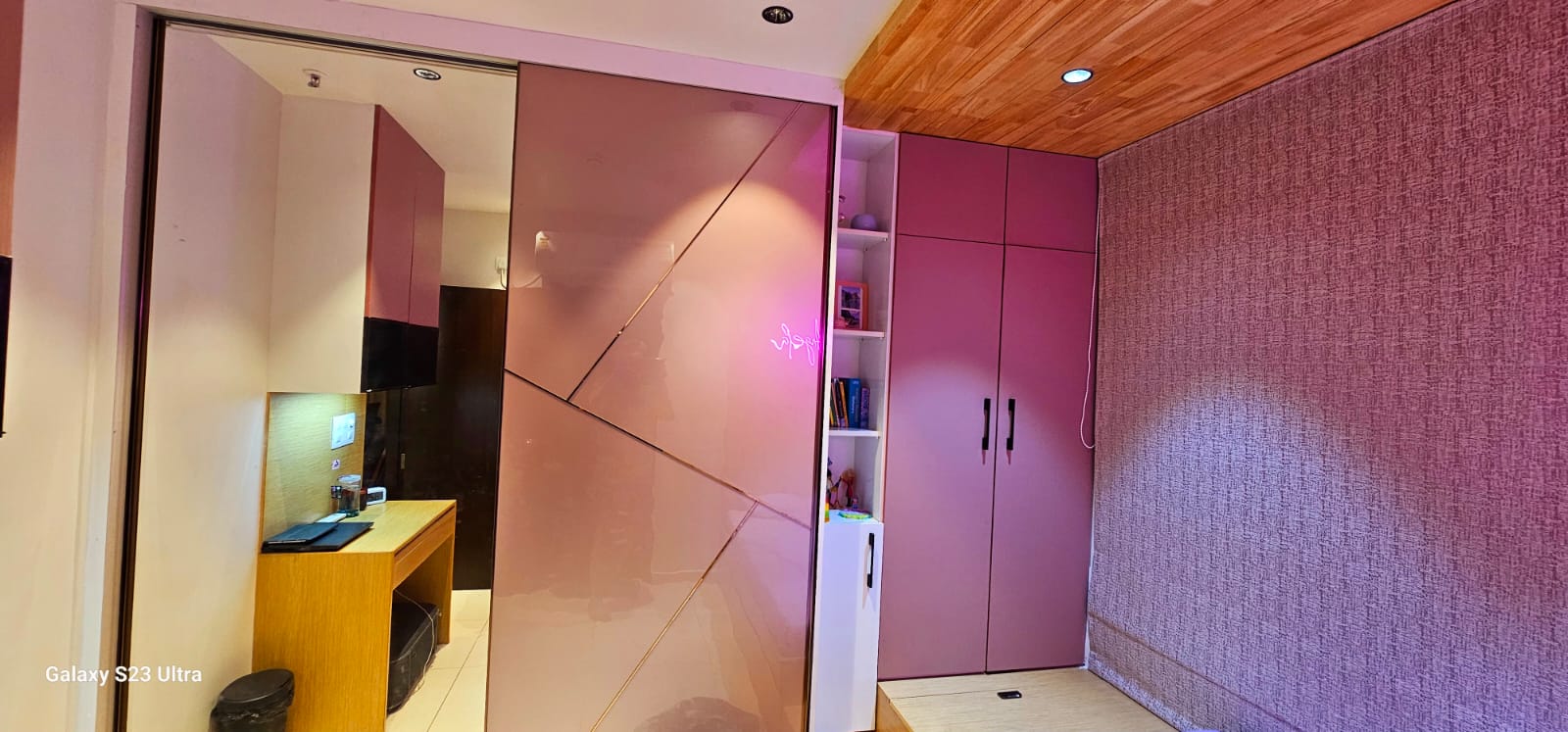Glossy pink angular-pattern wardrobe with open shelving