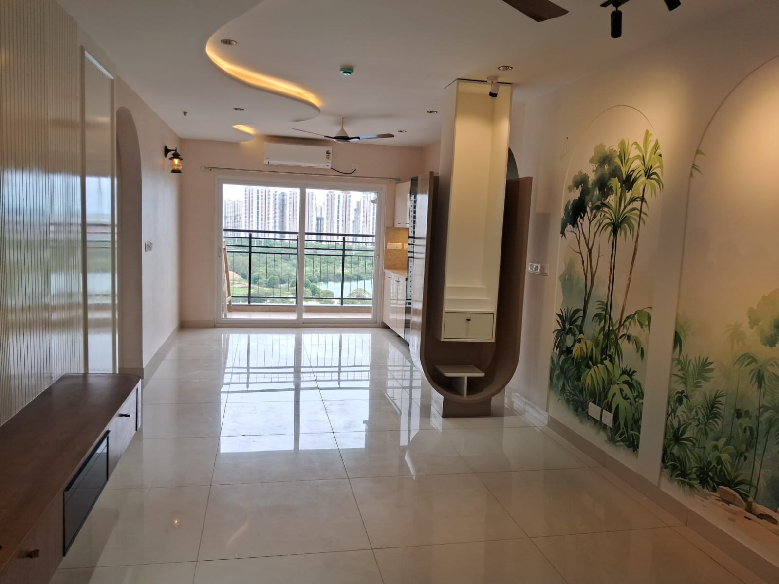 Living room with hand-painted tropical mural, arched niches and lake view balcony